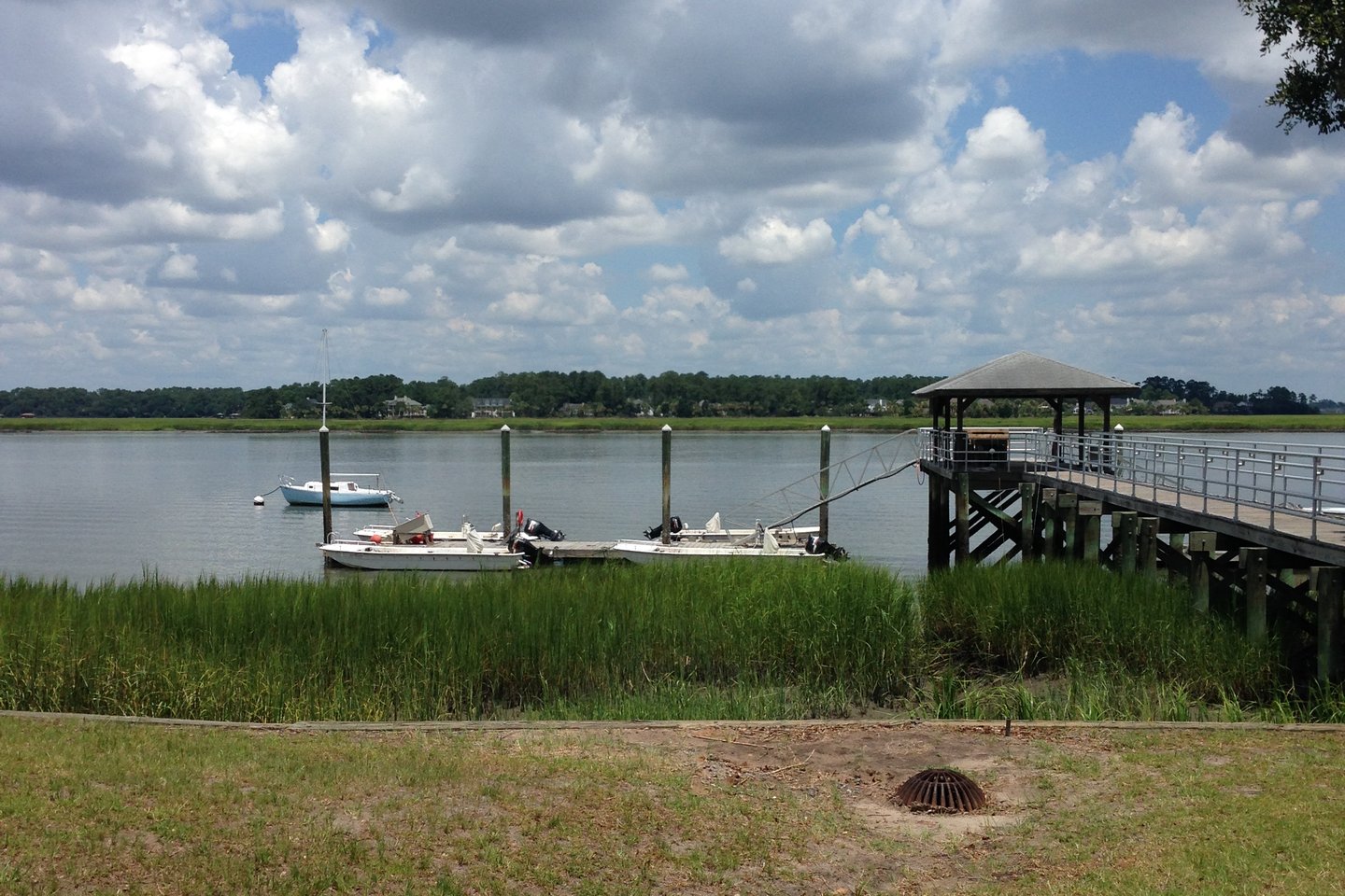 A wooden dock reaches over salt marsh and tidal water on the Skidaway River in Chatham County, Georgia